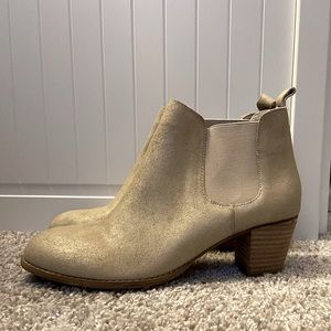 Shiny gold and white heeled booties